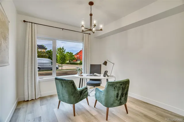 a view of a dining room with furniture window and wooden floor