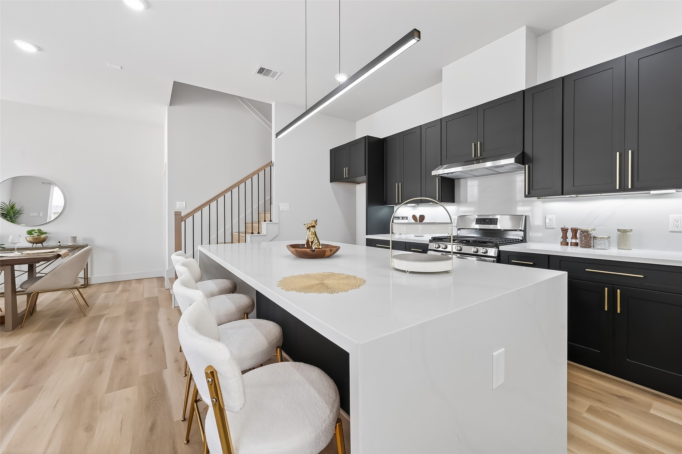 975 Highland Light Lane Houston, TX 77091 - Photo 14 of 41 a kitchen with a table chairs a stove a microwave and cabinets