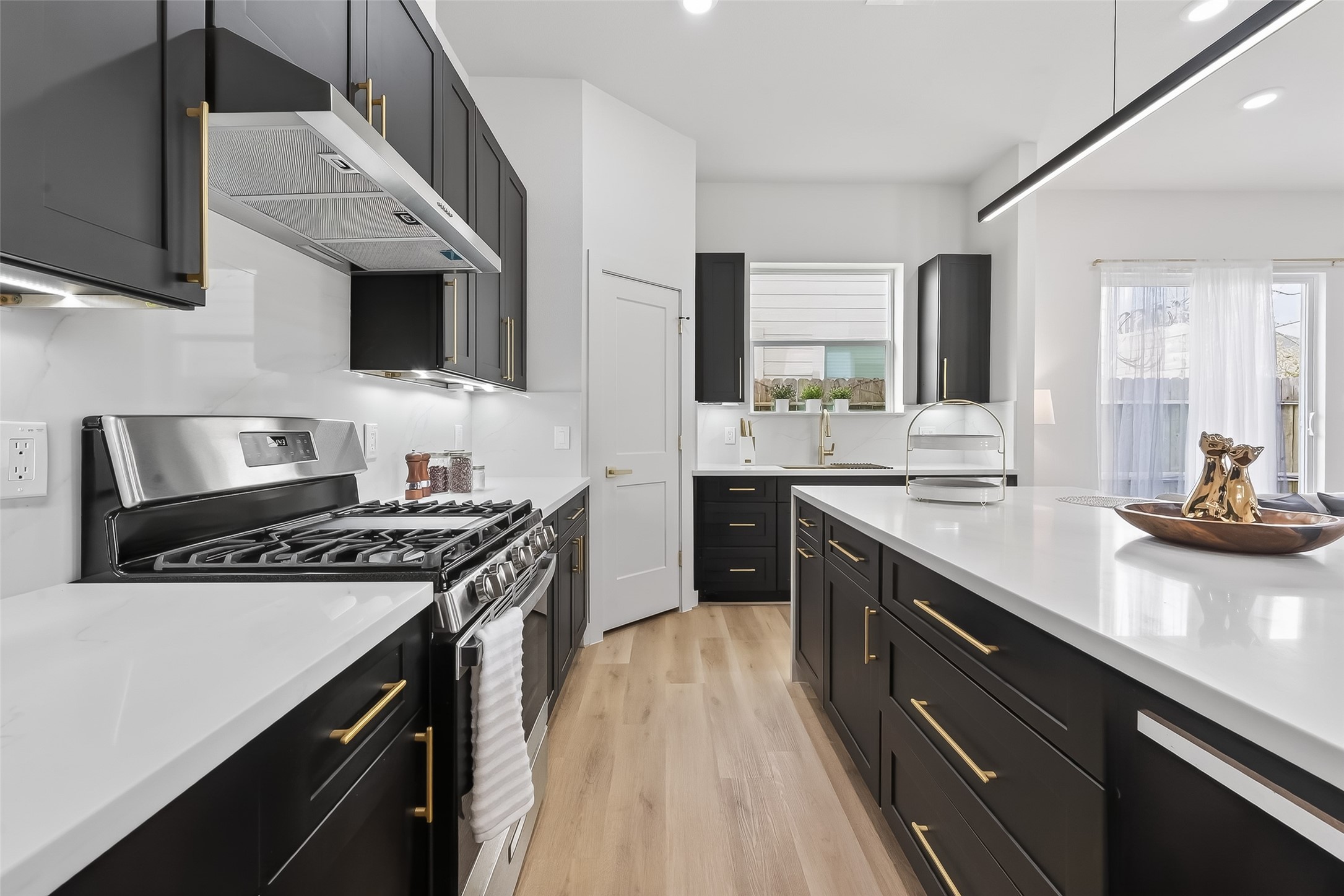 975 Highland Light Lane Houston, TX 77091 - Photo 20 of 41 a kitchen with a stove and a sink