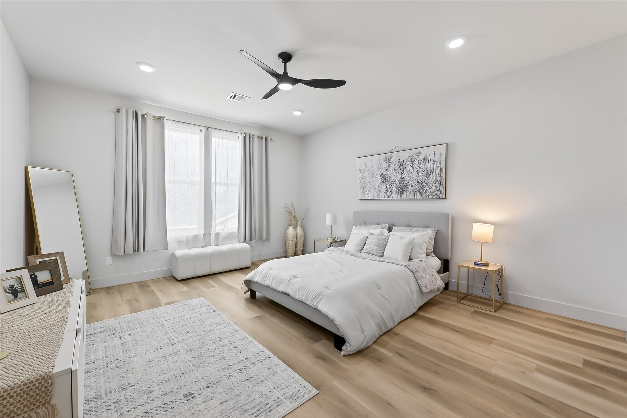 975 Highland Light Lane Houston, TX 77091 - Photo 24 of 41 a spacious bedroom with a bed a couch and a window