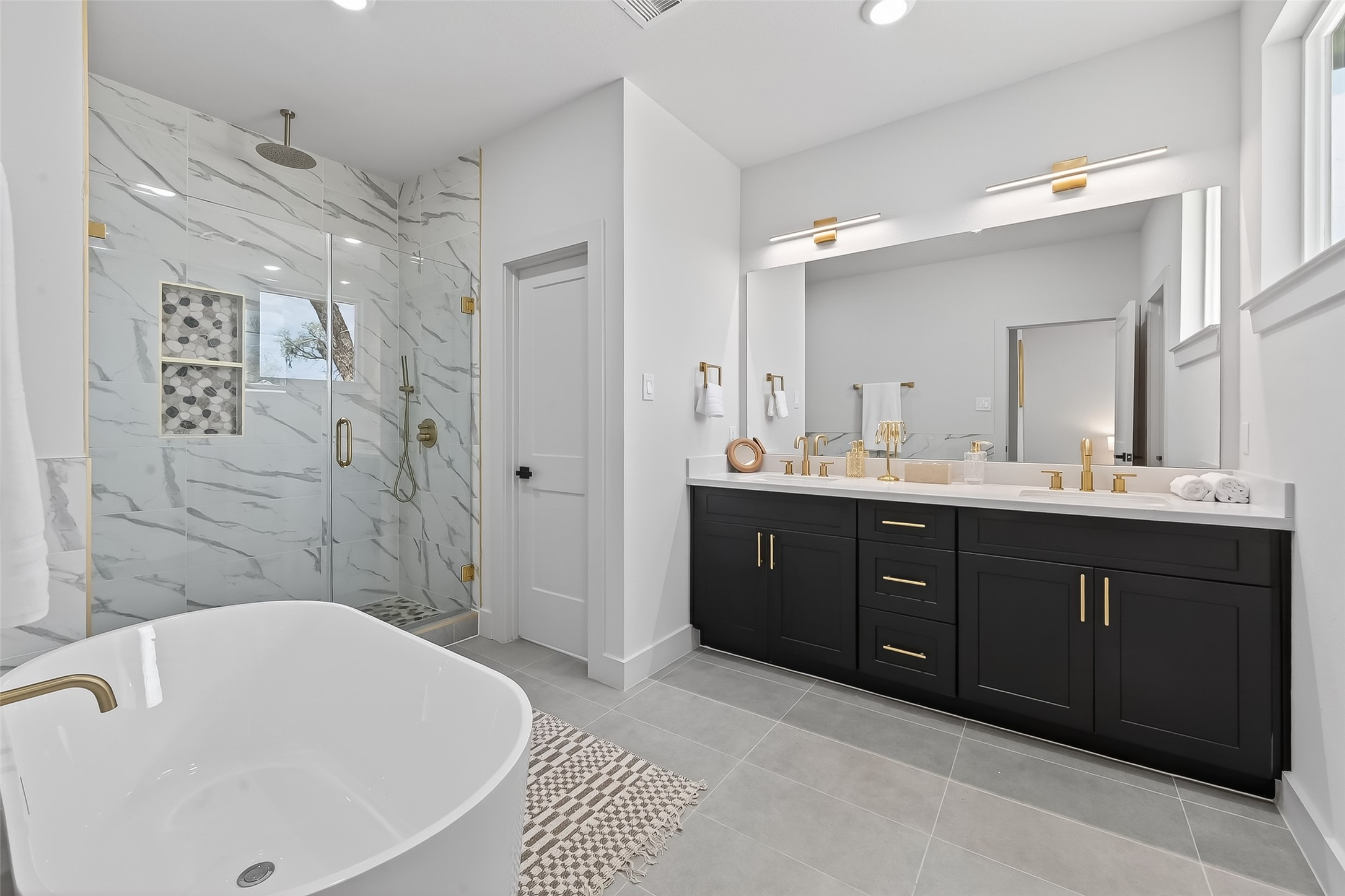 975 Highland Light Lane Houston, TX 77091 - Photo 26 of 41 a spacious bathroom with a tub sink shower and mirror