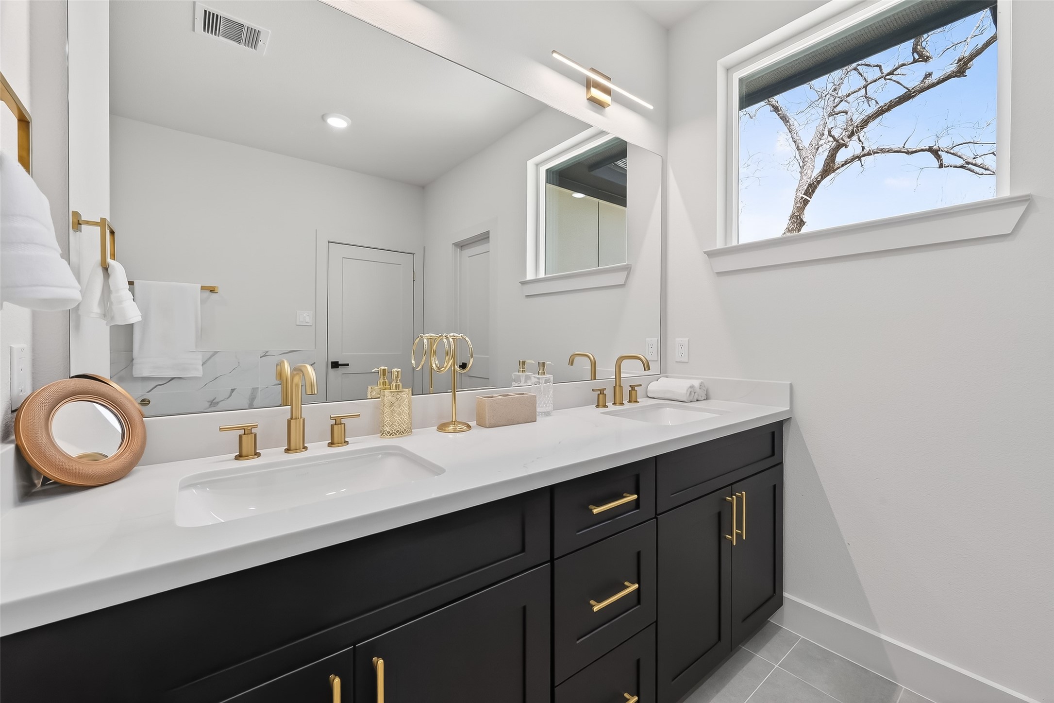 975 Highland Light Lane Houston, TX 77091 - Photo 29 of 41 a bathroom with a sink double vanity and a mirror