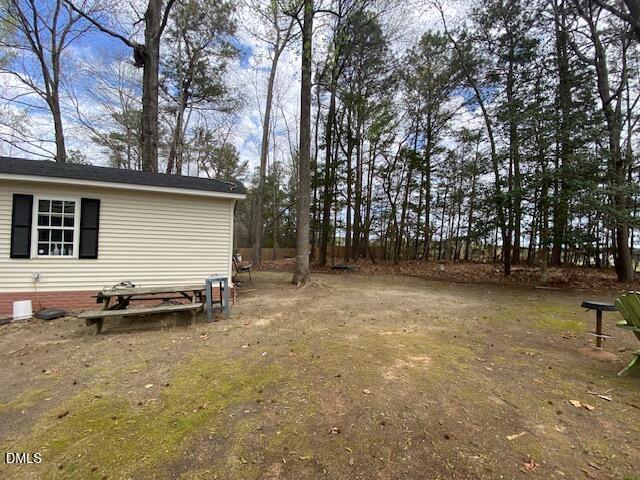 23 South Chaucer Way Kittrell, NC 27544 - Photo 28 of 28 a backyard of a house with lots of green space