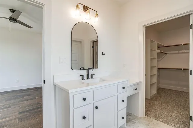 a bathroom with a double vanity sink and mirror