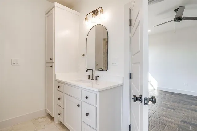 a bathroom with a double vanity sink and mirror