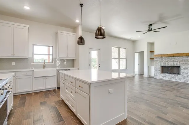 a kitchen with a stove window and a fireplace