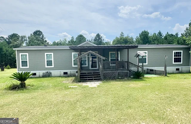 a backyard of a house with table and chairs