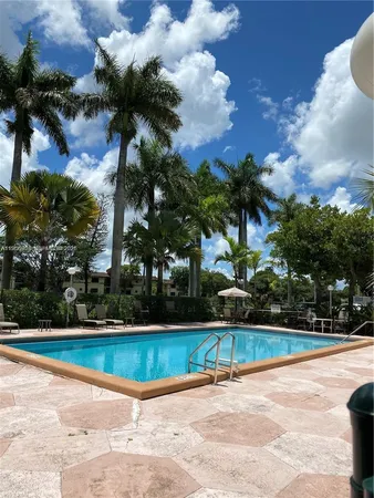 a view of a swimming pool and a yard