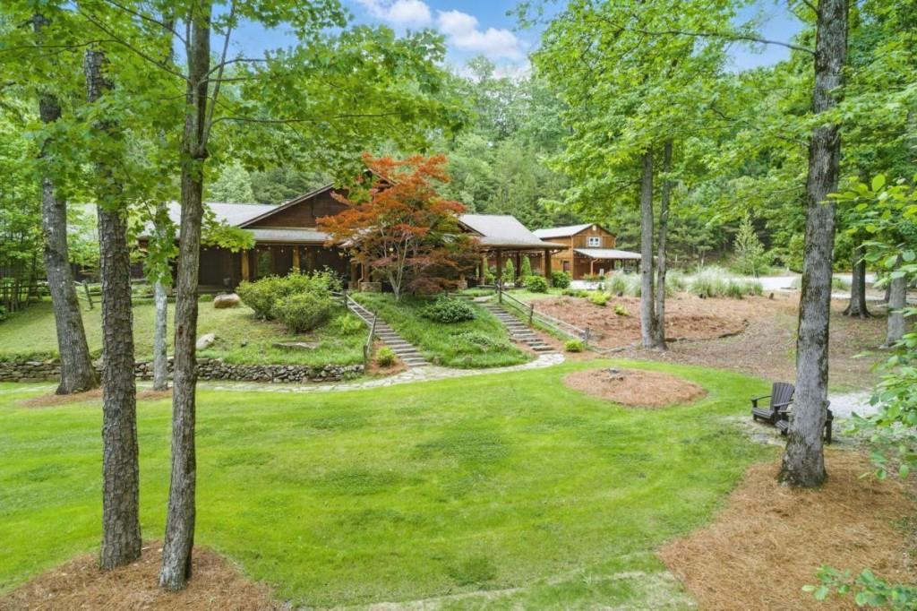 a view of a backyard with table and chairs under an umbrella