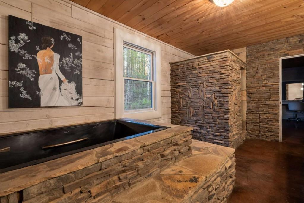 230 Old Mill White Road Jasper, GA 30143 - Photo 35 of 65 a bedroom with a bed and a painting on the wall