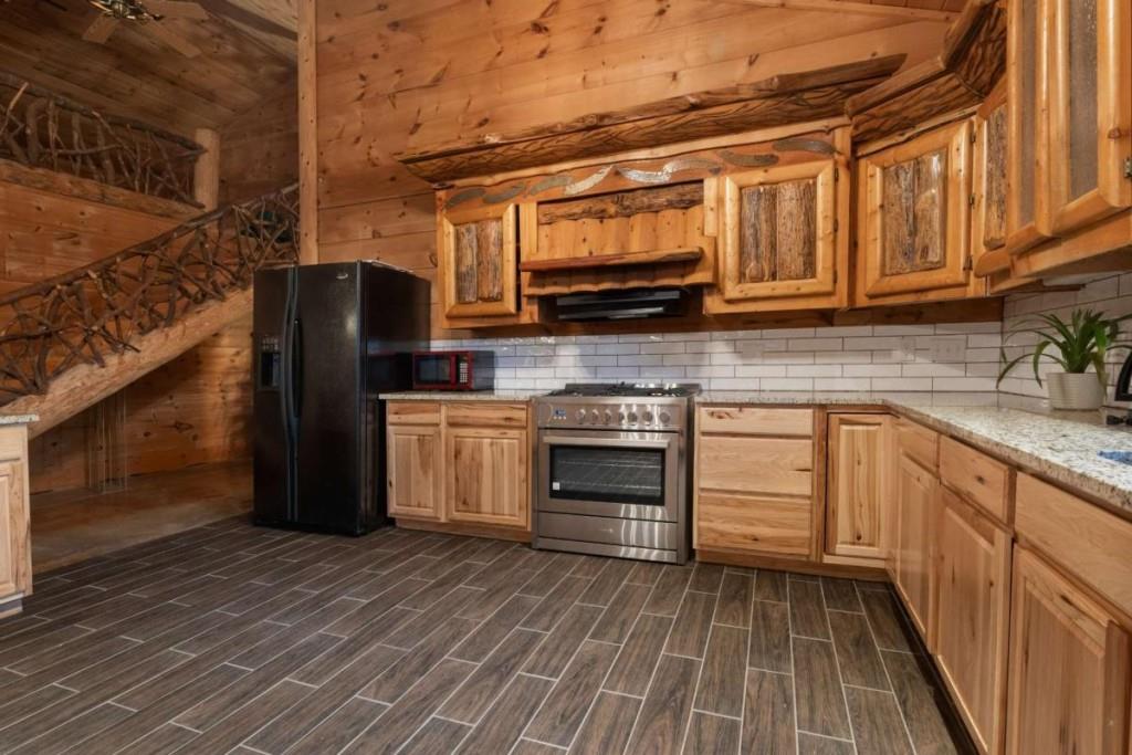 230 Old Mill White Road Jasper, GA 30143 - Photo 42 of 65 a kitchen with stainless steel appliances granite countertop a refrigerator and a stove top oven