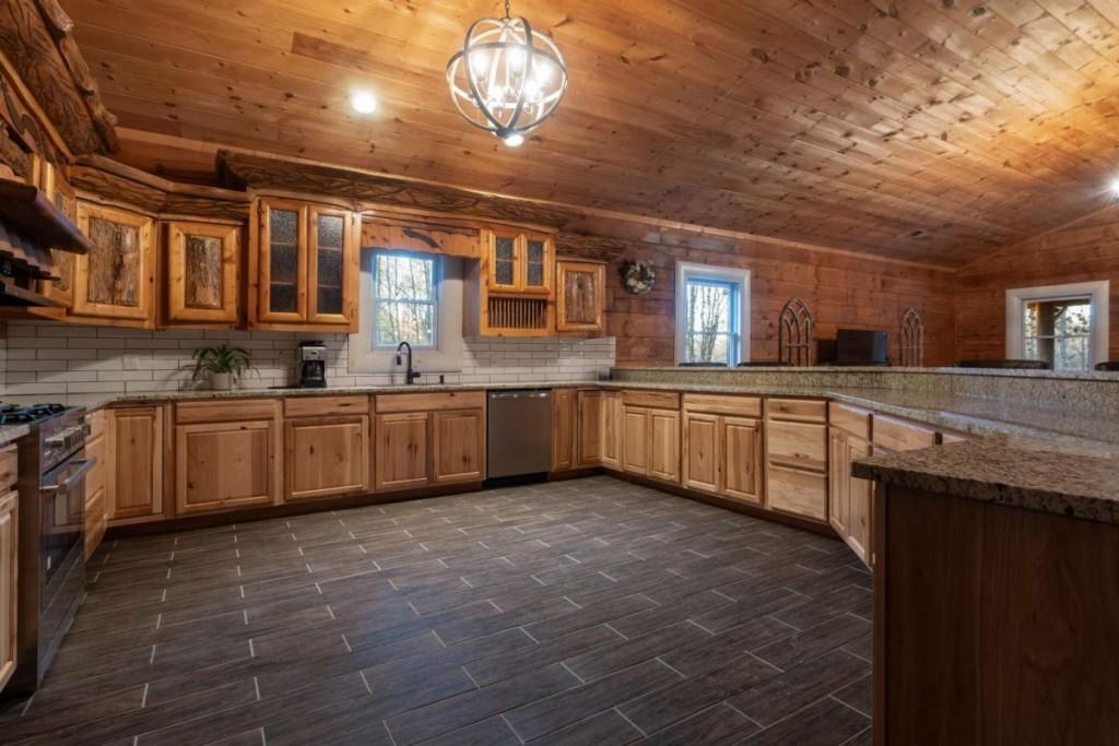230 Old Mill White Road Jasper, GA 30143 - Photo 43 of 65 a large kitchen with a large counter space a sink and cabinets