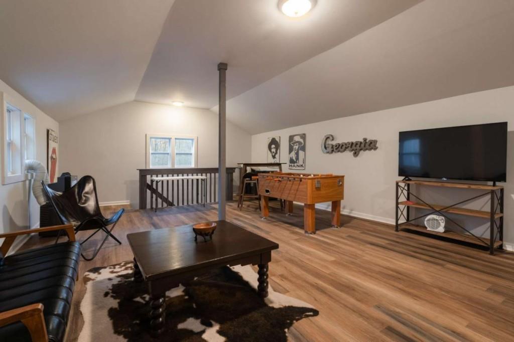 230 Old Mill White Road Jasper, GA 30143 - Photo 48 of 65 a living room with furniture a flat screen tv and a floor to ceiling window