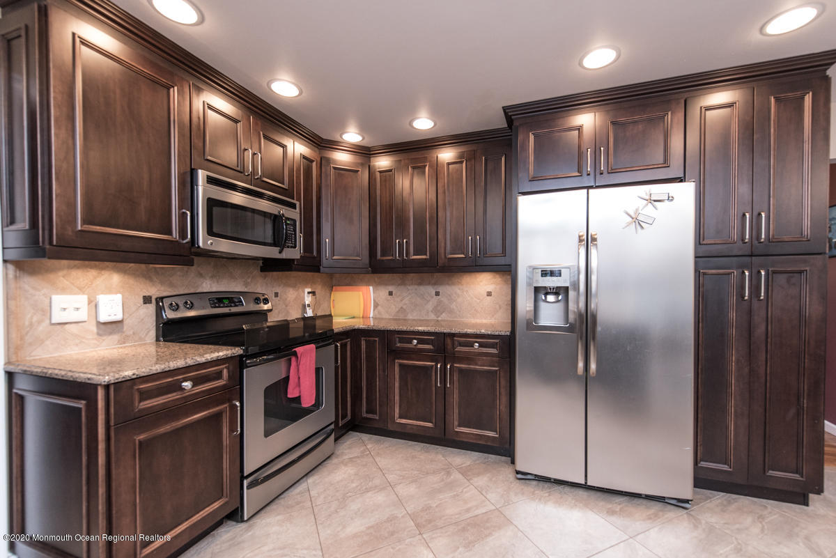 138 Frank Applegate Road Jackson, NJ 08527 - Photo 20 of 47 a kitchen with stainless steel appliances granite countertop a refrigerator a stove a sink and a microwave
