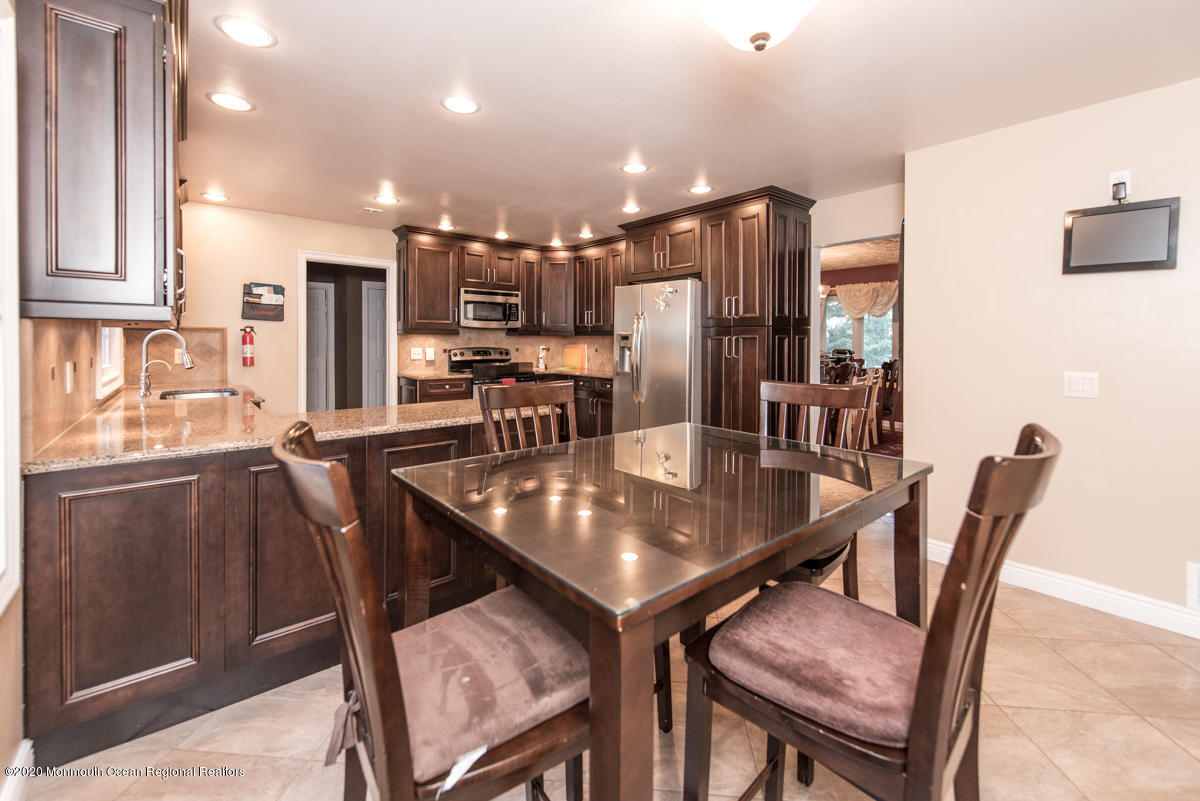 138 Frank Applegate Road Jackson, NJ 08527 - Photo 21 of 47 a kitchen with stainless steel appliances granite countertop a dining table chairs and granite counter tops