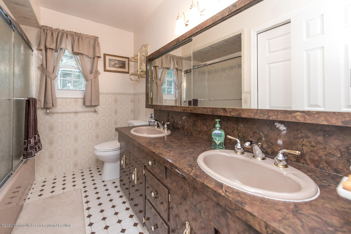 138 Frank Applegate Road Jackson, NJ 08527 - Photo 38 of 47 a bathroom with a sink a toilet and a mirror