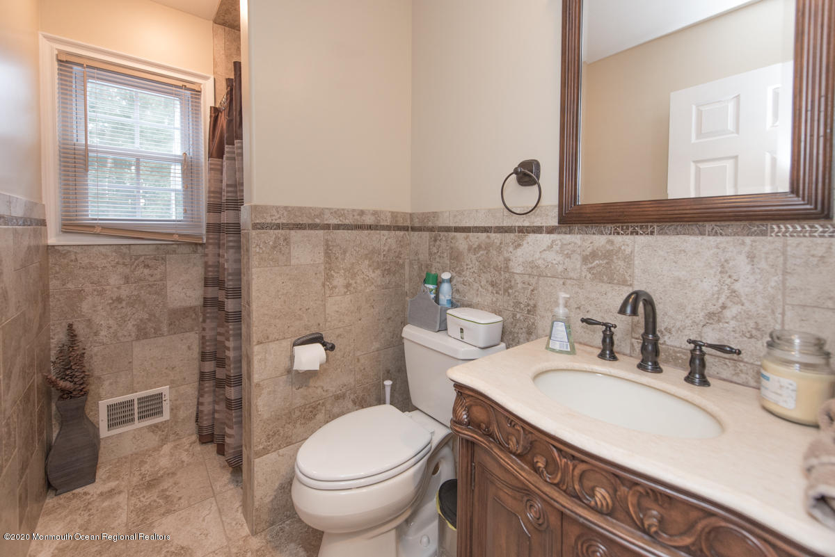 138 Frank Applegate Road Jackson, NJ 08527 - Photo 41 of 47 a bathroom with a granite countertop toilet sink and mirror