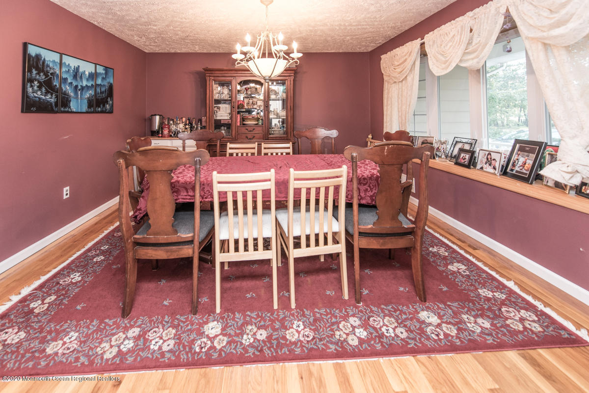 138 Frank Applegate Road Jackson, NJ 08527 - Photo 10 of 47 a dining room with furniture a rug and a chandelier