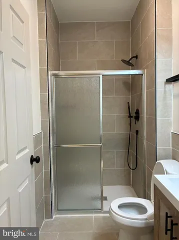 a bathroom with a toilet and shower