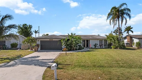 a front view of house with yard and trees