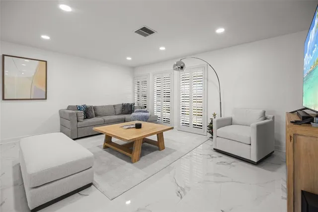 a kitchen with stainless steel appliances a table chairs refrigerator and sink