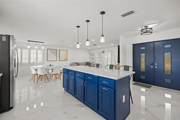 a kitchen with granite countertop white cabinets and stainless steel appliances