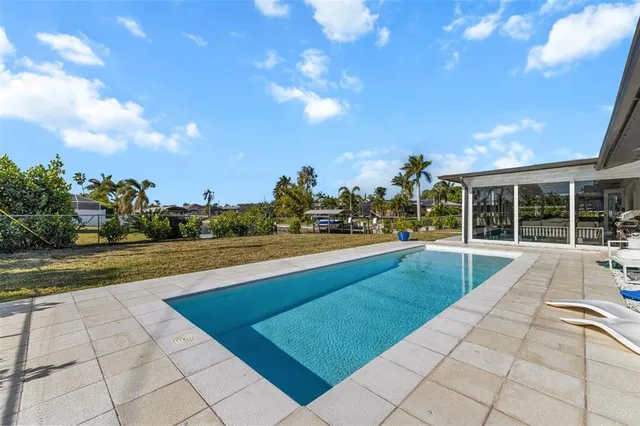 a view of swimming pool with seating area