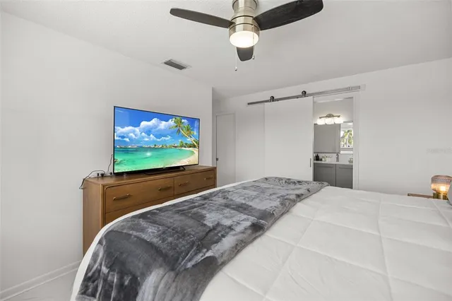 a bathroom with a sink and mirror with shower