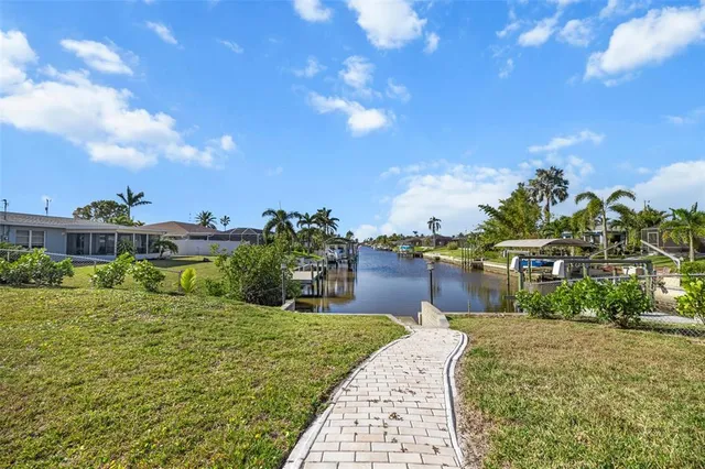 a view of a patio with table and chairs with wooden floor and fence