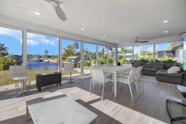 a view of a dining room with furniture a chandelier and wooden floor