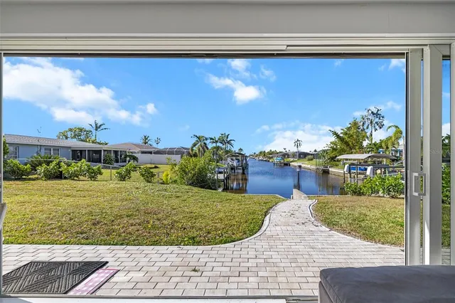 a living room with furniture a flat screen tv and a table