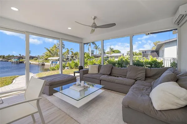 a living room with furniture and a potted plant