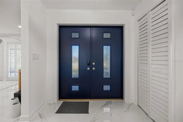 a living room with furniture a window and a flat screen tv