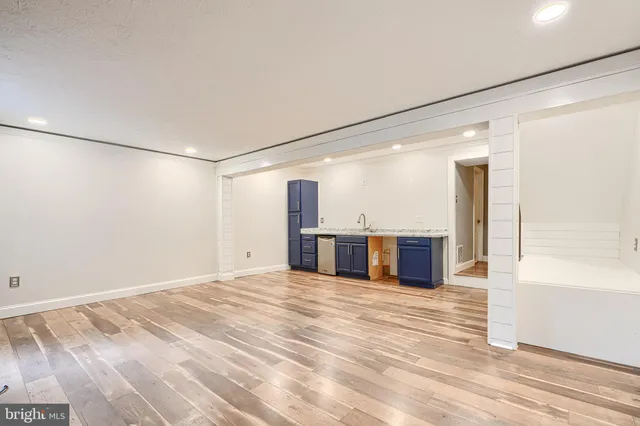 a view of a kitchen with a sink and a large window