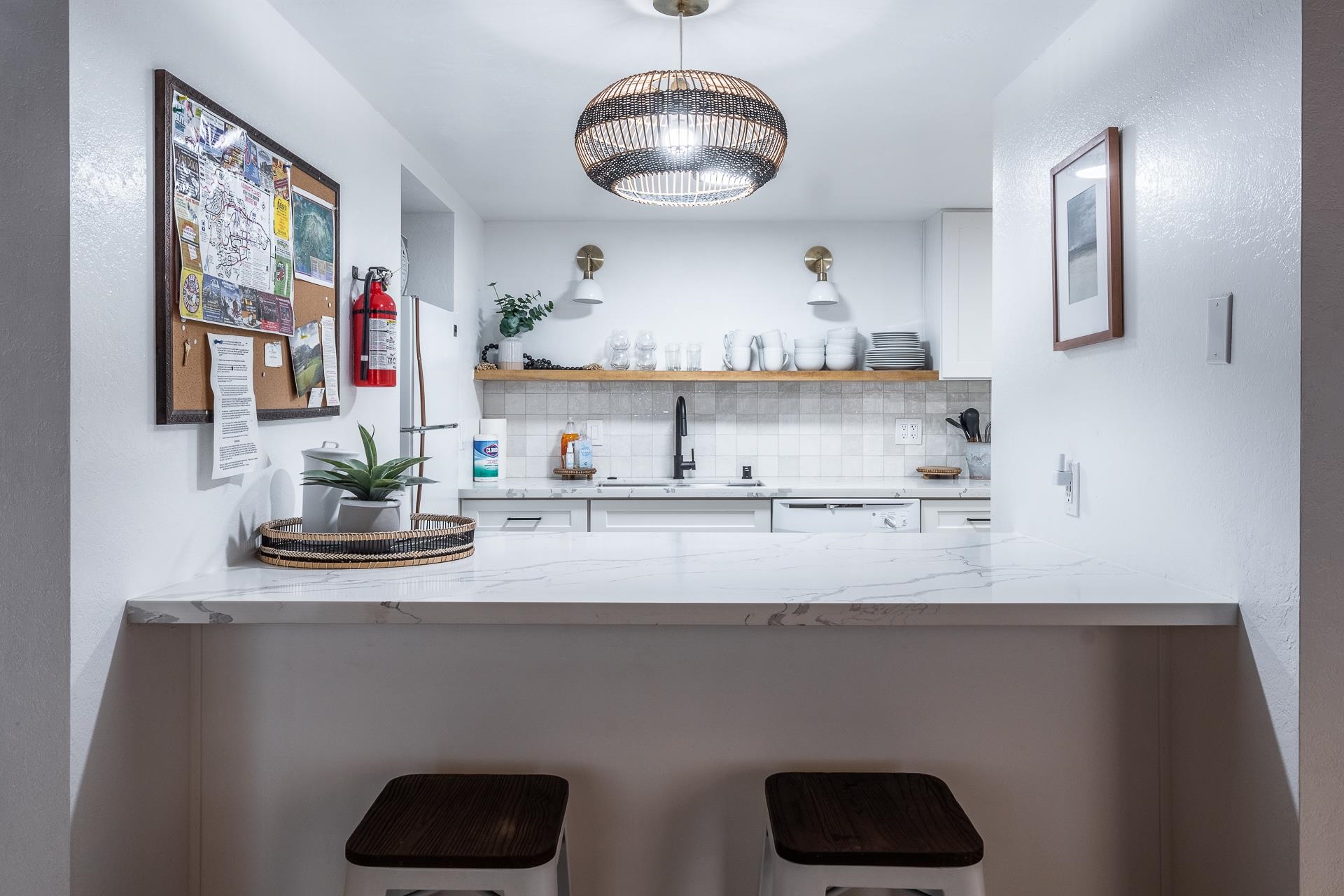 2289 Sierra Nevada Road, Unit J8 Mammoth Lakes, CA 93546 - Photo 15 of 30 Indoor wet bar featuring light stone counters, white cabinetry, decorative backsplash, and a textured wall