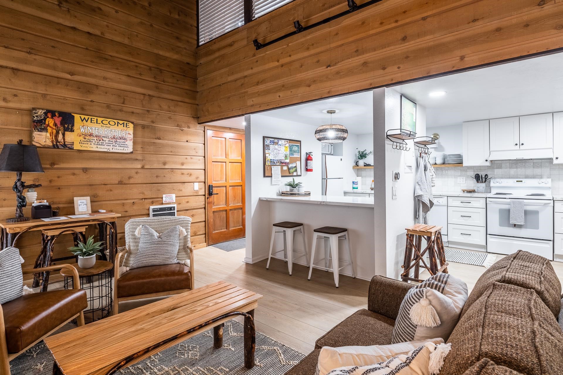 2289 Sierra Nevada Road, Unit J8 Mammoth Lakes, CA 93546 - Photo 22 of 30 Living area featuring light wood-style floors and wood walls