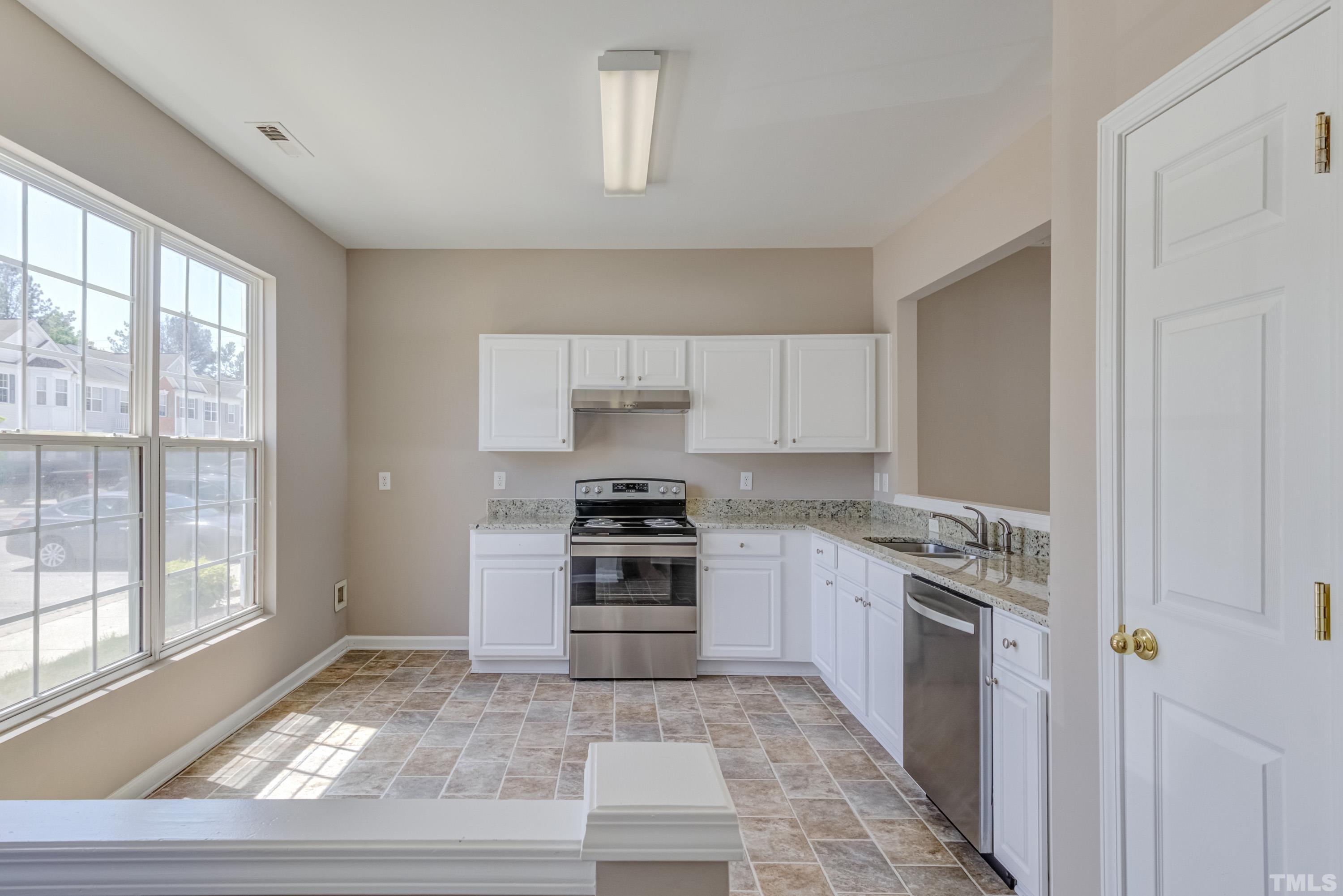 5328 Glen Canyon Road Raleigh, NC 27616 - Photo 7 of 35 a kitchen with a stove and a sink