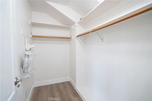 a view of walk in closet with empty racks