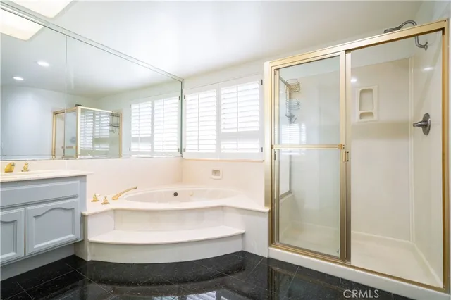a bathroom with a tub shower and sink
