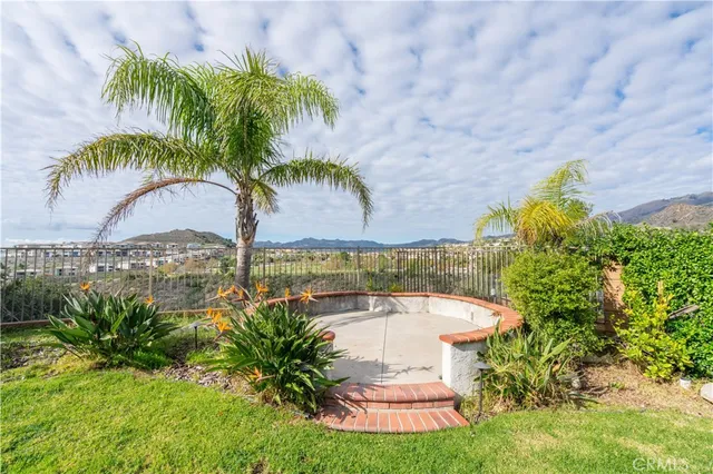 a view of a yard with a fountain and a garden