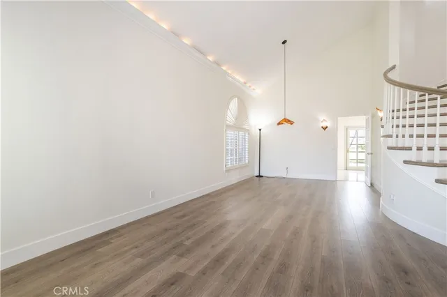 a view of a room with wooden floor