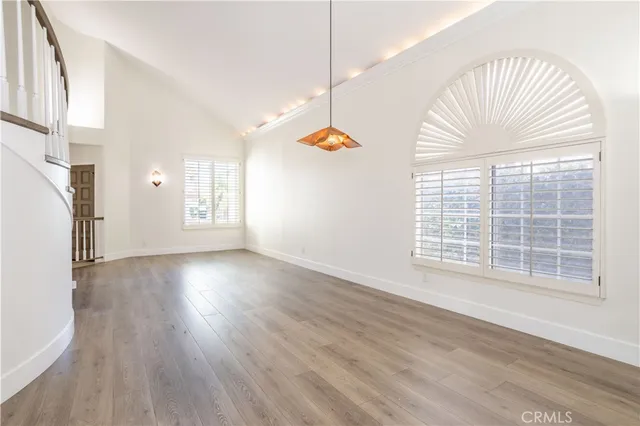 a view of a livingroom with wooden floor and a window