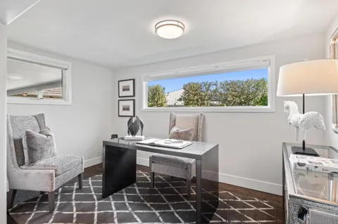 a view of a workspace with furniture