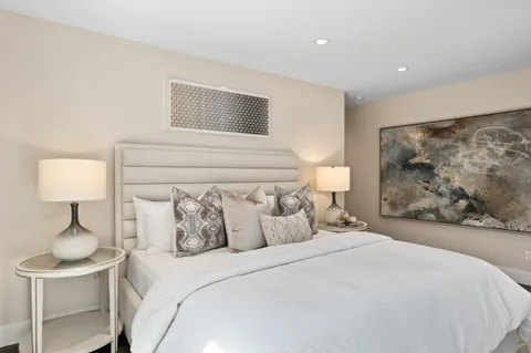 a bedroom with a bed and a lamp