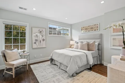 a bedroom with a bed and a chair