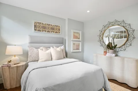 a bedroom with a bed and a mirror