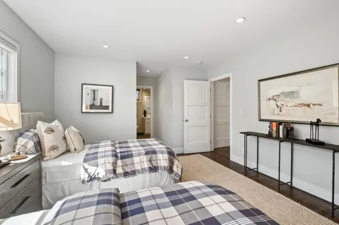a bedroom with a bed and painting on the wall