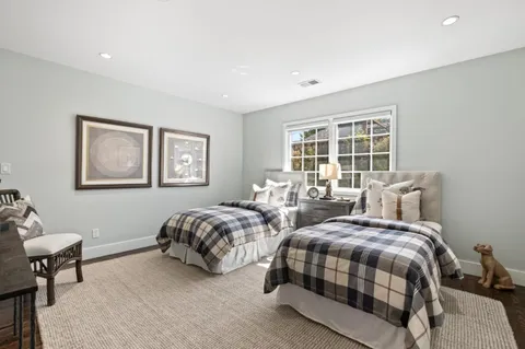 a bedroom with two beds and a window