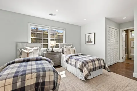 a bedroom with two beds and a window