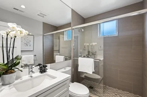 a bathroom with a sink a toilet and shower